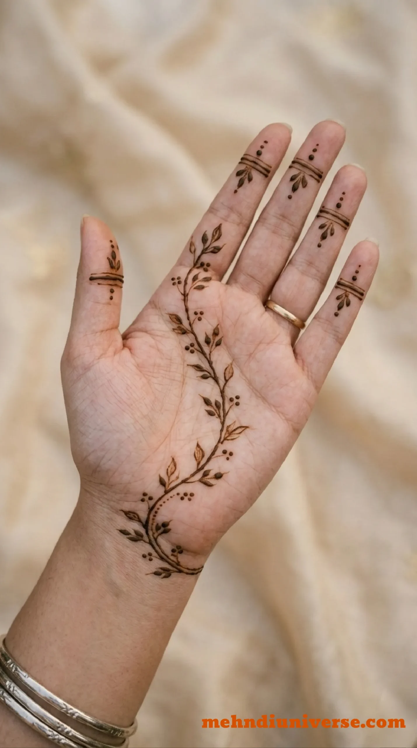 Simple elegant mehndi design with trailing vine pattern on palm and front hand 09 v2